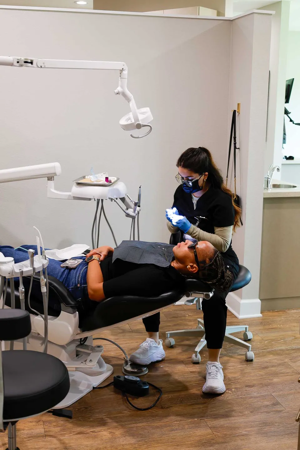 Hygienist caring for a patient in a modern treatment room
