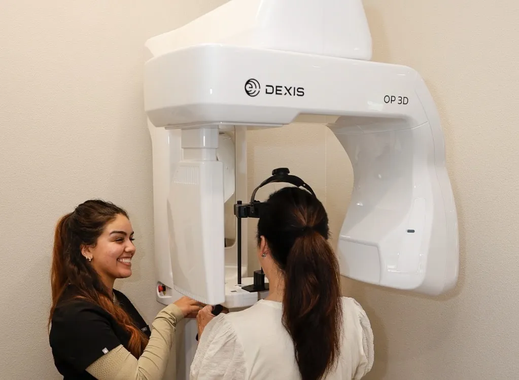Team member helping a patient with a 3D dental scan